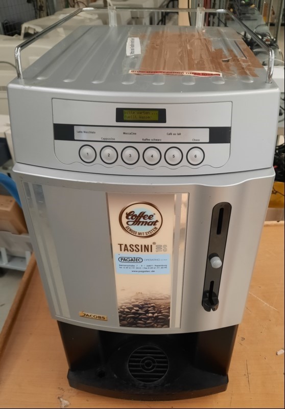 Rheavendors Kaffeeautomat Tassini 100S, Seriennummer: 20180810171, inkl. 3 Schlüssel, mit Münzfach, Gerät verschmutzt-Wartung ist nötig, Deckel stark mit Klebestreifen beklebt, siehe Bilder, Gerät nur elektrisch geprüft(lässt sich einschalten-Disp...